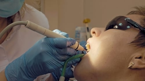 Woman Ultrasonic Tooth Plaque Odontolith Removing