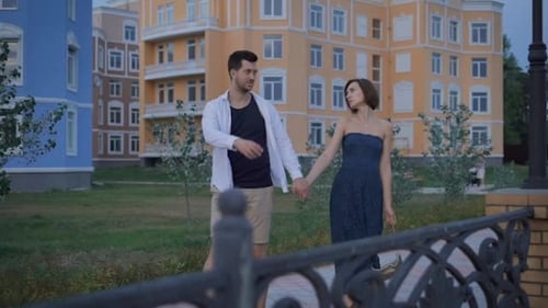 Happy Couple Newlyweds Fun Stroll Along The Promenade Near His New Home.