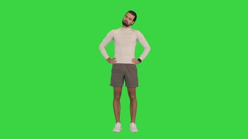 Young Man Warming Up His Neck on a Green Screen Chroma Key