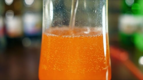 Refreshing Orange Soda Being Poured Close Up