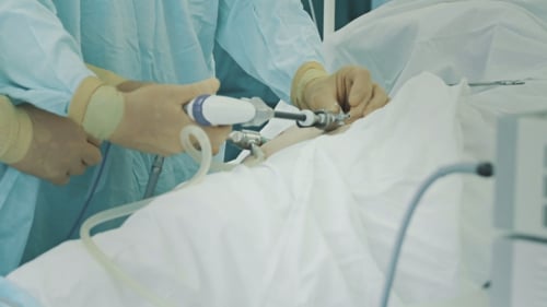 Surgeons Team Performing Operation In Hospital Operating Room.