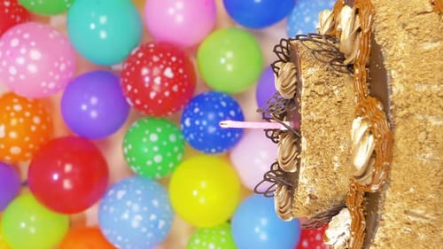 Festive Birthday Cake with Balloons and Candles