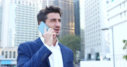 Man in Blazer Talking on Phone in City