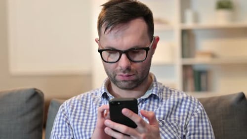 Man Using Smartphone at Home