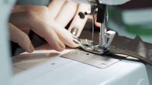 Close Up Shot of Female Hands Working on Sewing Machine
