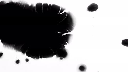 Expanding Black Inkblot on White Surface