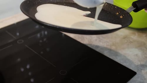 Close-up of the Pouring Dough on the Pan. Cooking Pancakes.