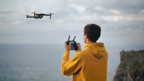 Drone Pilot Flying Near Ocean on Beautiful Cliff