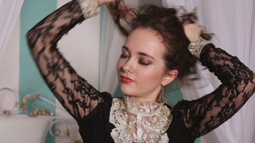 Woman Puts Up Hair in a Lacy Vintage Top