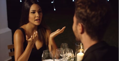 Woman Talking to Man at Romantic Candlelit Dinner