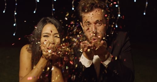 Glamorous Couple Blows Confetti at Night