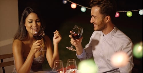 Romantic Young Couple Enjoying Dinner And Wine