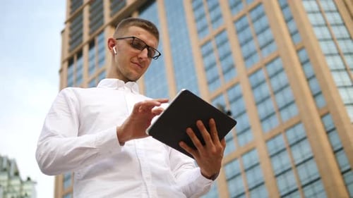 Man Using Tablet in Urban Setting