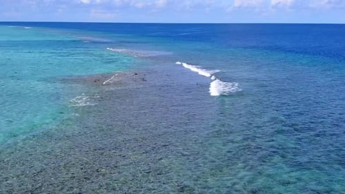Drone aerial panorama of shore beach break by blue sea and sand background