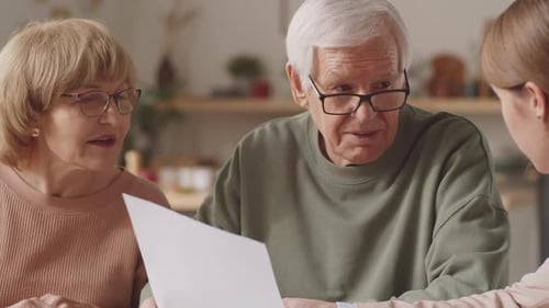 Senior Couple Consulting with Young Adult Indoors