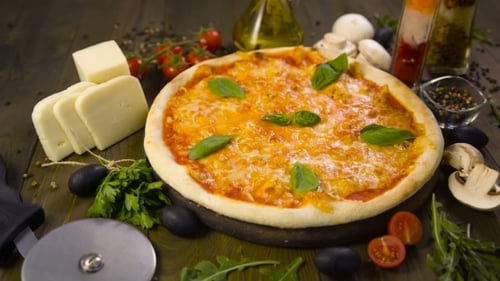 Pizza With Mozzarella, Cheese And Basil Leaves