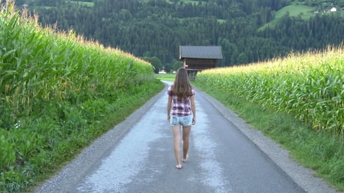 Barefoot Woman Walks Down Country Road