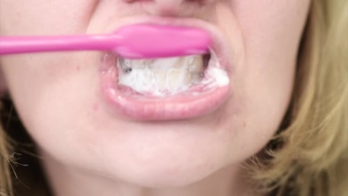 Woman Brushing Teeth in Extreme Close Up