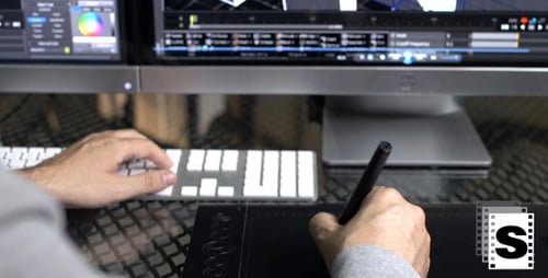 Person using Graphic Tablet and Keyboard at Desk