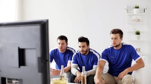 Friends Or Football Fans Watching Soccer At Home
