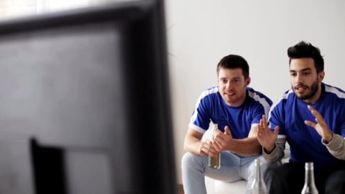 Friends Or Football Fans Watching Soccer At Home