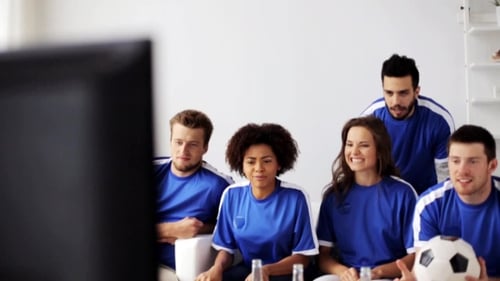 Friends Cheer While Watching Football Match Indoors