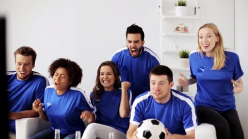 Friends Cheering and Celebrating a Soccer Game at Home