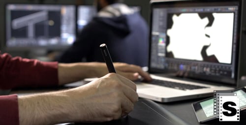 Graphic Designer Working with Pen Tablet in Office