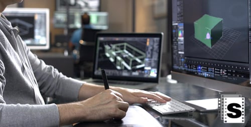 Creative Designer Using Tablet and Computer for 3D Graphics