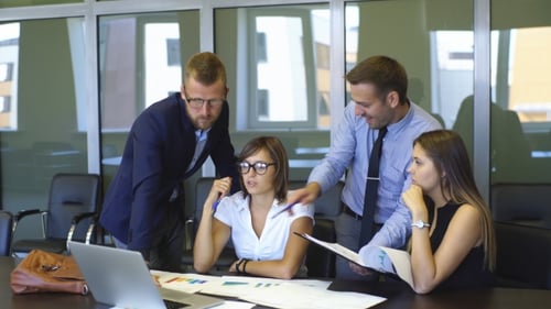 Professionals Discussing Data in Bright Modern Office