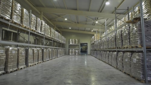Large Furniture Warehouse. Mezzanine Shelving With Large Packages Of Food Ready For Dispatch