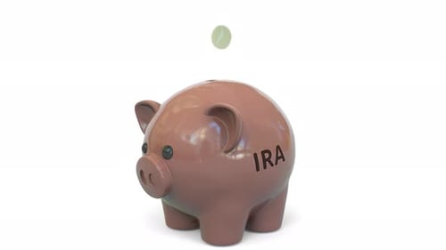 Money Fall Into Piggy Bank with Individual Retirement Account IRA Text