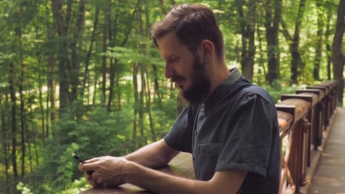 Male Texting Sms On The Cell In The Forester.