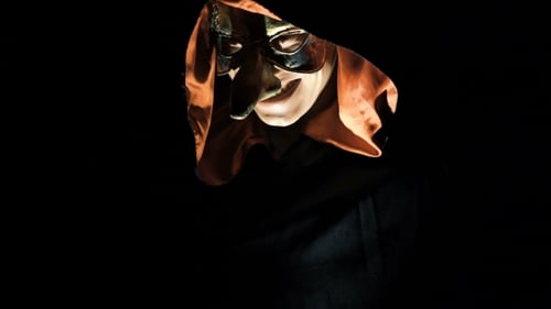 Evil Figure Smiling in Hooded Mask in the Dark