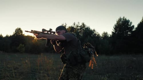 Soldier in Camo with Rifle in Rural Setting