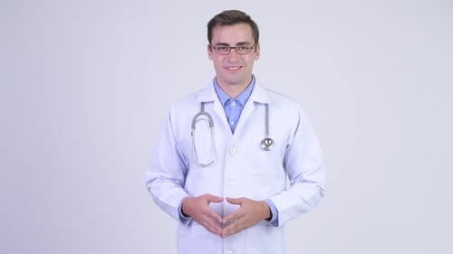 Young Doctor Gesturing and Smiling in White Coat