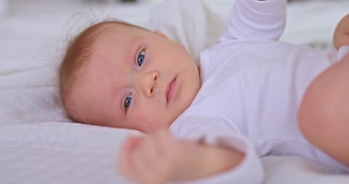 Sweet Infant Lying on Bed, Close Up