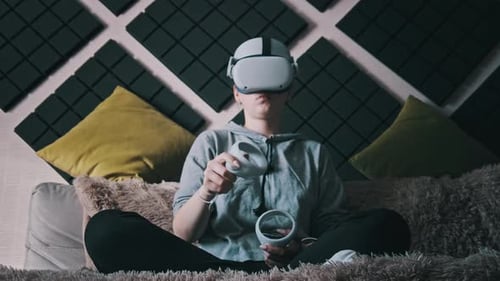Young Woman Uses VR Headset at Home on Couch
