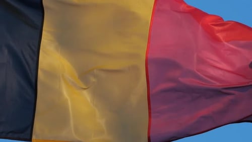 Belgian Flag Waving Against Blue Sky