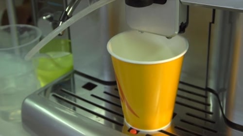 Creamy Liquid Dispensing into a Yellow Paper Cup