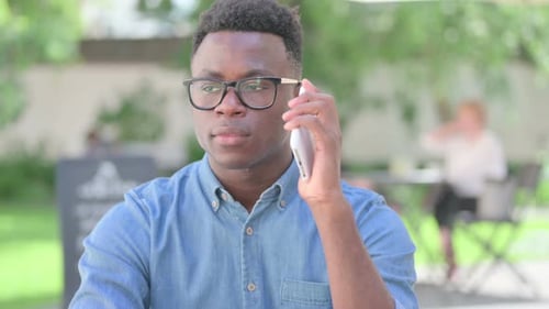 Young Adult Talking on Cellphone in Urban Setting