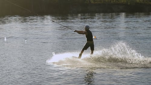 Wakeboarder Making Tricks On Sunset