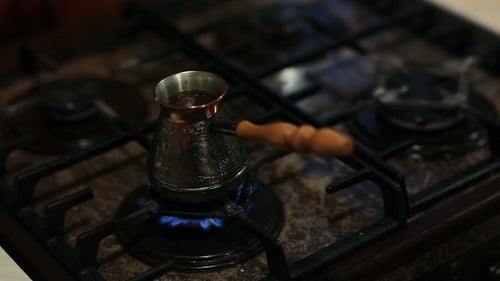 A View Of Coffee In a Coffee Pot Preparing On Fire.