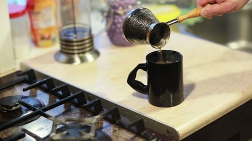 Fresh Coffee Poured into Mug in Home Kitchen