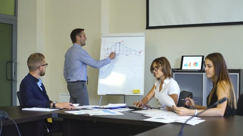 Team Discussing Data at Meeting in Modern Office