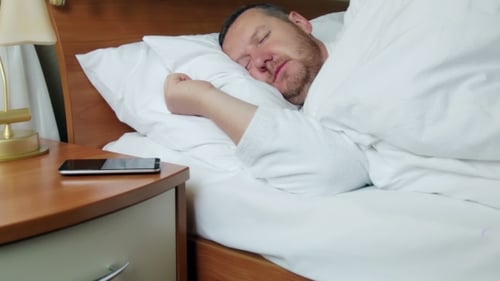 Man Sleeping, Wakes up, Uses Cell Phone