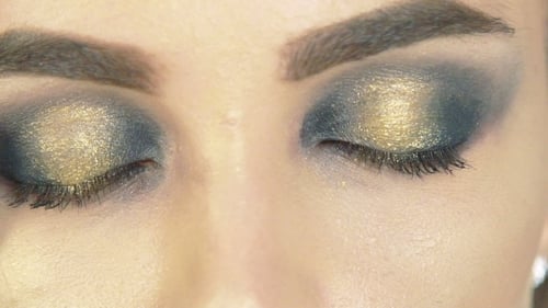 Adult Woman with Glamorous Gold and Gray Eye Makeup
