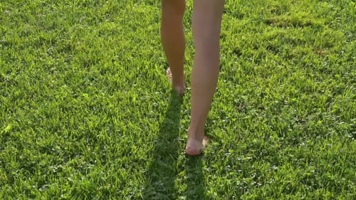 Woman Walk Barefoot On Soft Grass