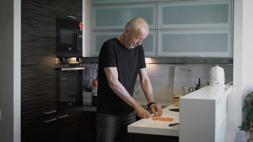Man Chopping Vegetables in Modern Kitchen