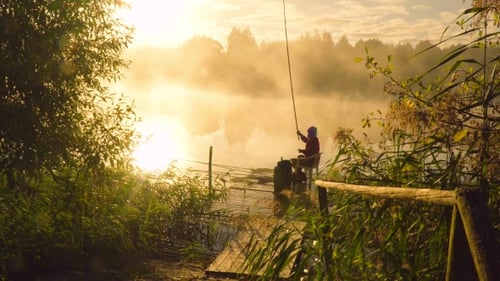 Lone Fisherman on Dock in Foggy Lake Sunrise
